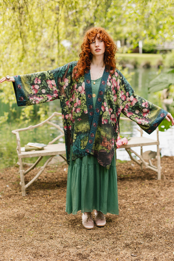 Woman wearing a floral kimono in a park setting